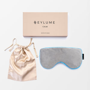 EYLUME Calm Heated Eye Mask complete set with luxury silk pouch and premium gift box displayed on a clean white background