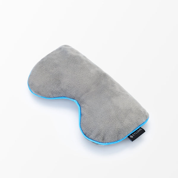 Side view of the EYLUME Calm Heated Eye Mask showing its contoured shape and premium plush material