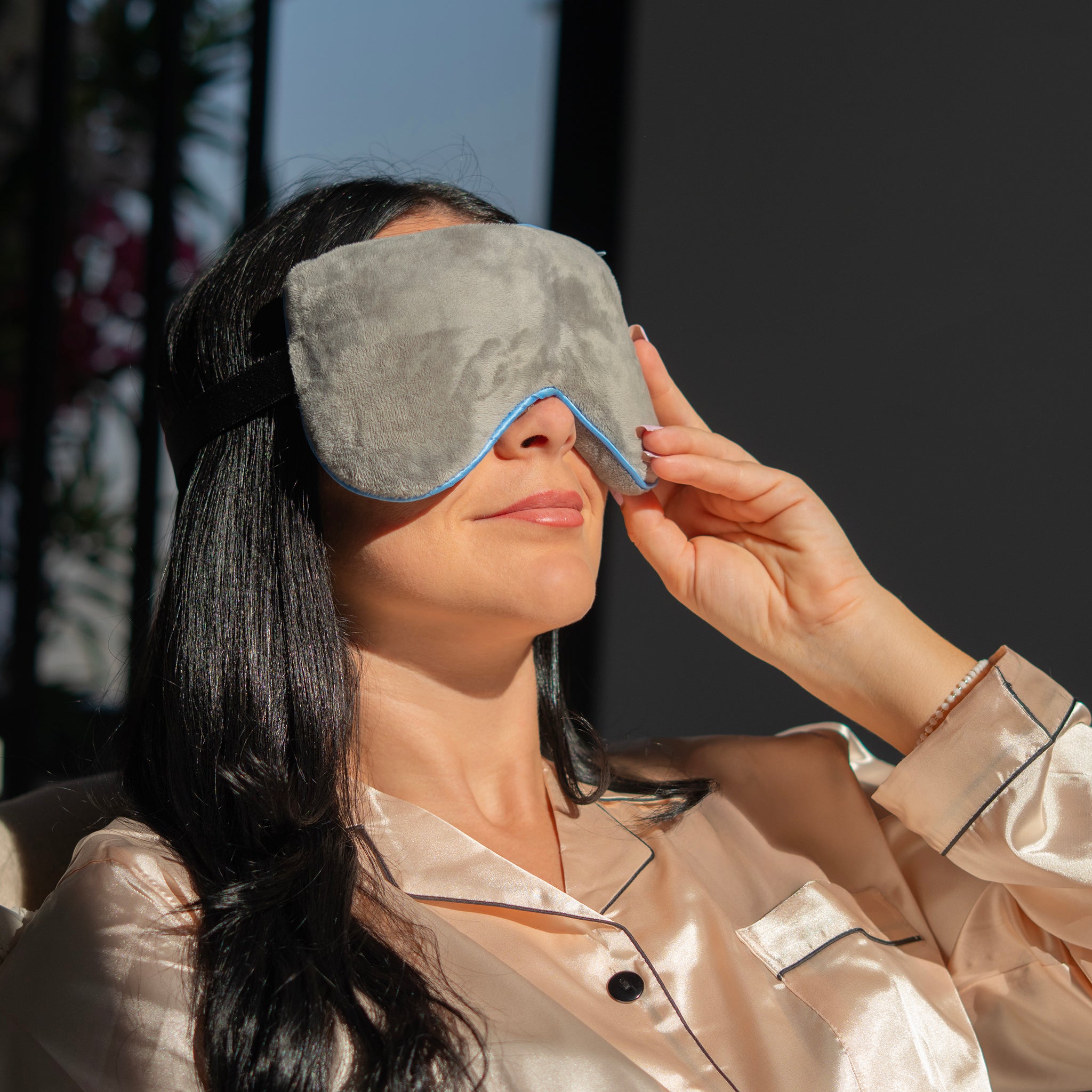 Woman wearing a heated eye mask to relieve dry, tired eyes with soothing comfort from EYLUME.