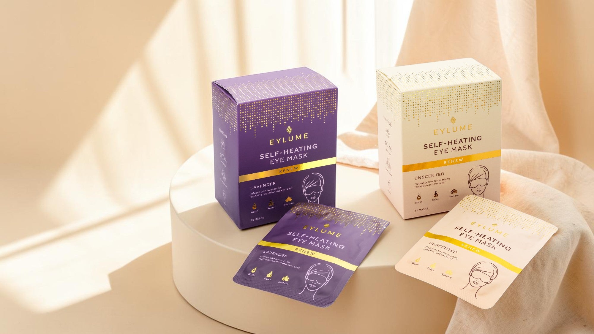 EYLUME Renew self-heating eye masks in lavender and unscented variants displayed on a premium wellness-inspired background